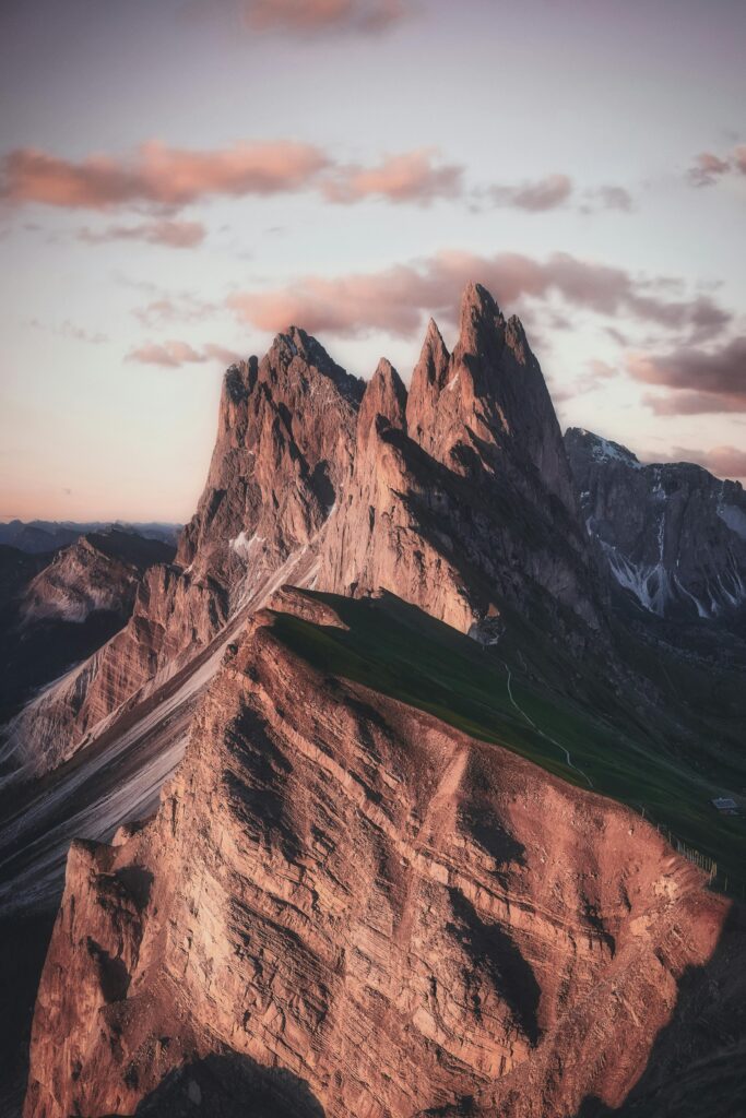 Breathtaking view of the sharp peaks of Seceda in the Dolomites during twilight, highlighting natural beauty.